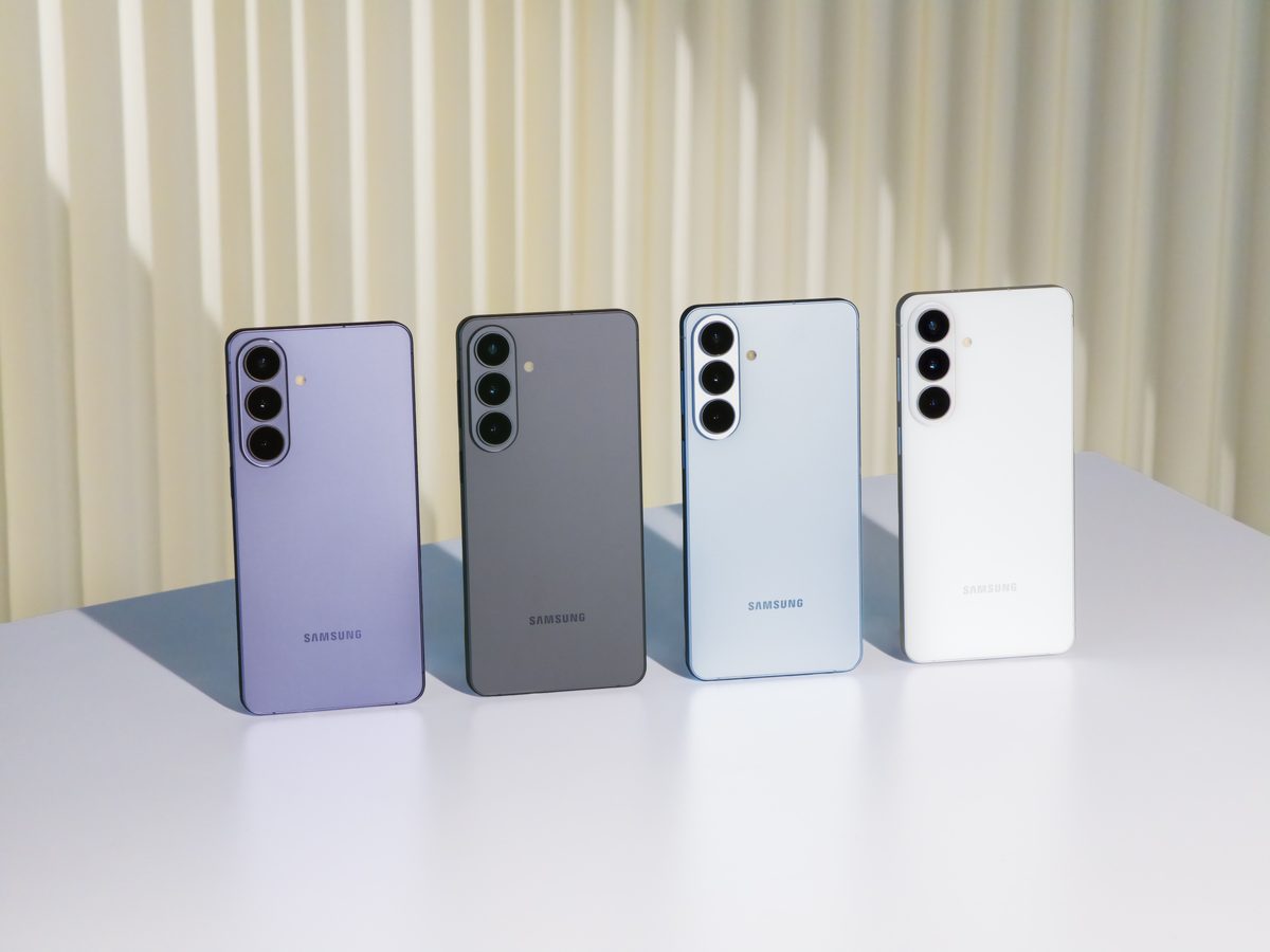 Samsung Galaxy S26 in its four launch colors lined up on a white table, rear view